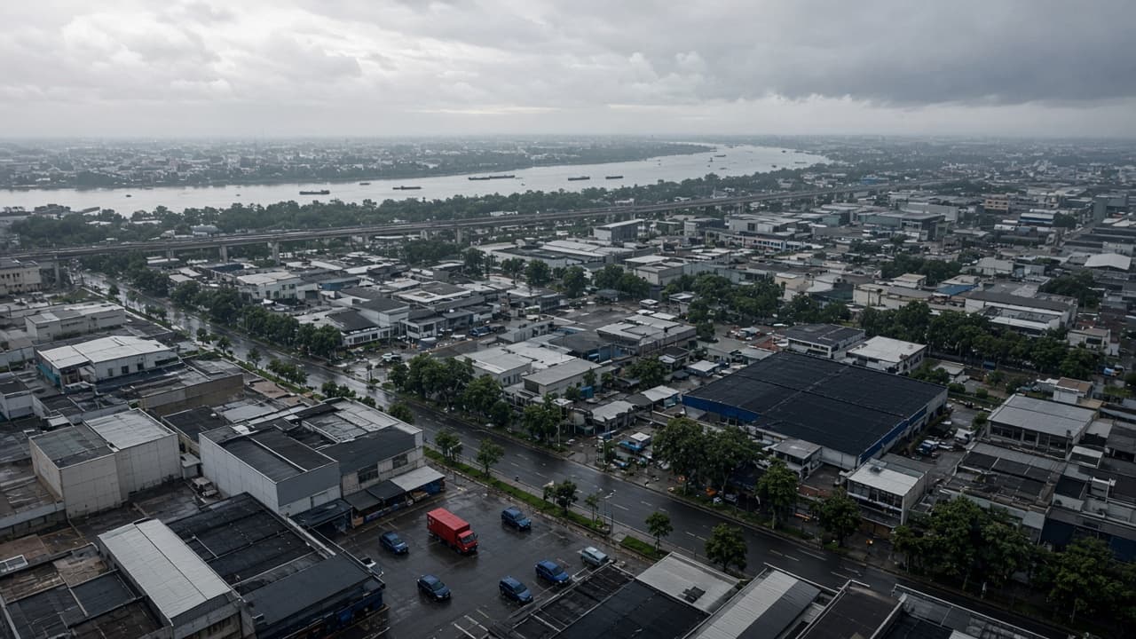 A Vietnamese commercial and logistics district beside a river after rain